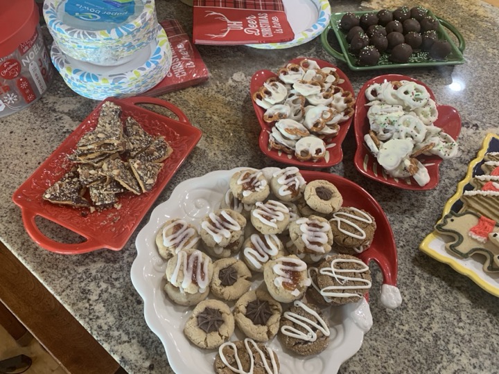 Assorted holiday cookies, pretzels, and treats on festive platters