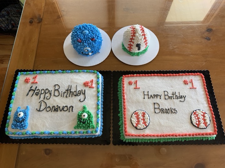Matching monster and baseball smash cakes with sheet cakes for first birthdays