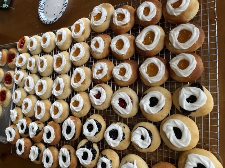 Rows of golden fruit-filled pastries with white icing rings