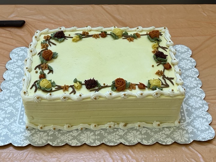 Cream sheet cake with autumn floral vine border and gold pearl accents