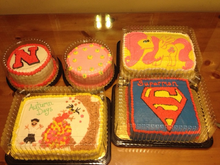 Group of themed cakes including Nebraska N, My Little Pony, and Superman designs